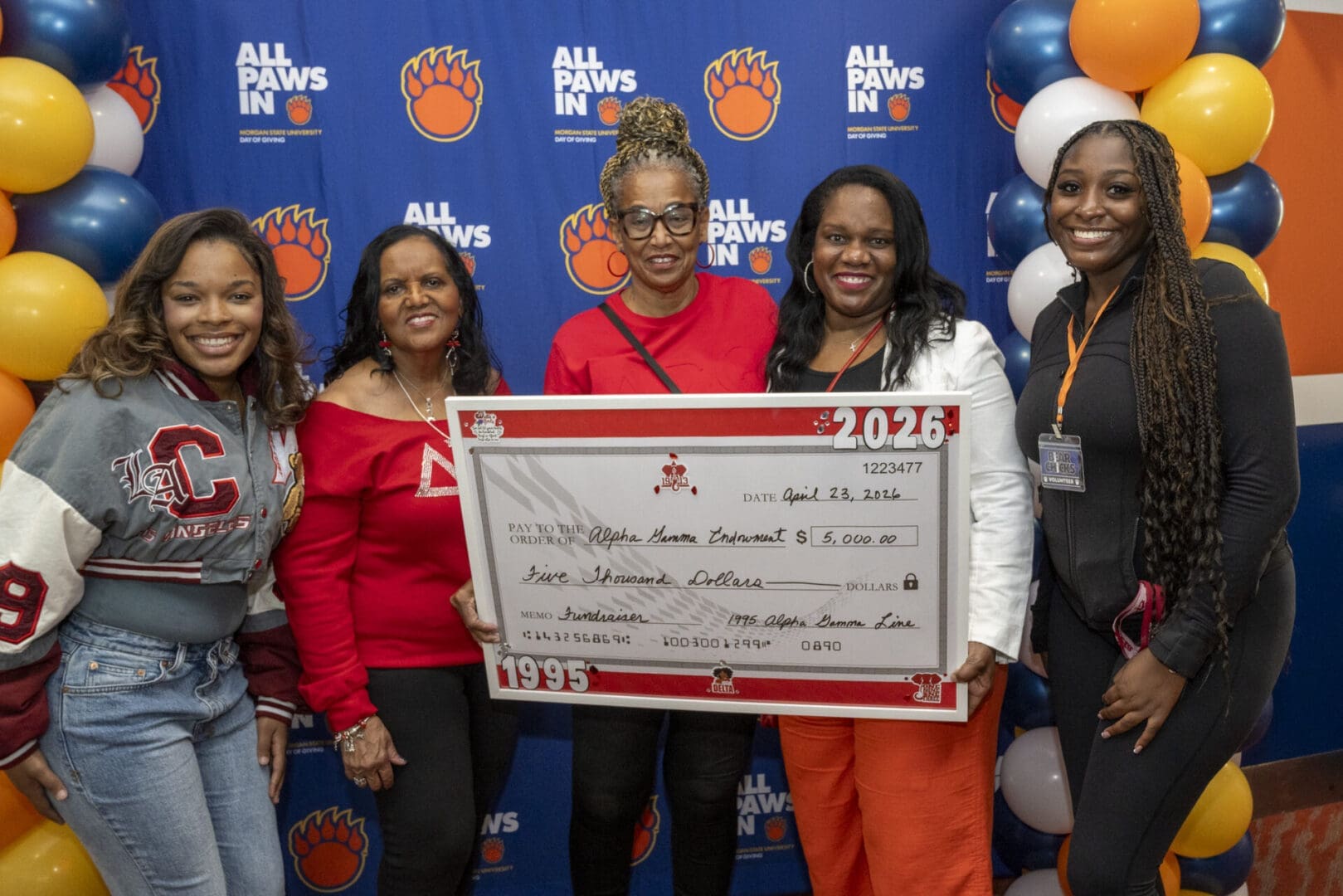 Image of group showing their donation to all paws in